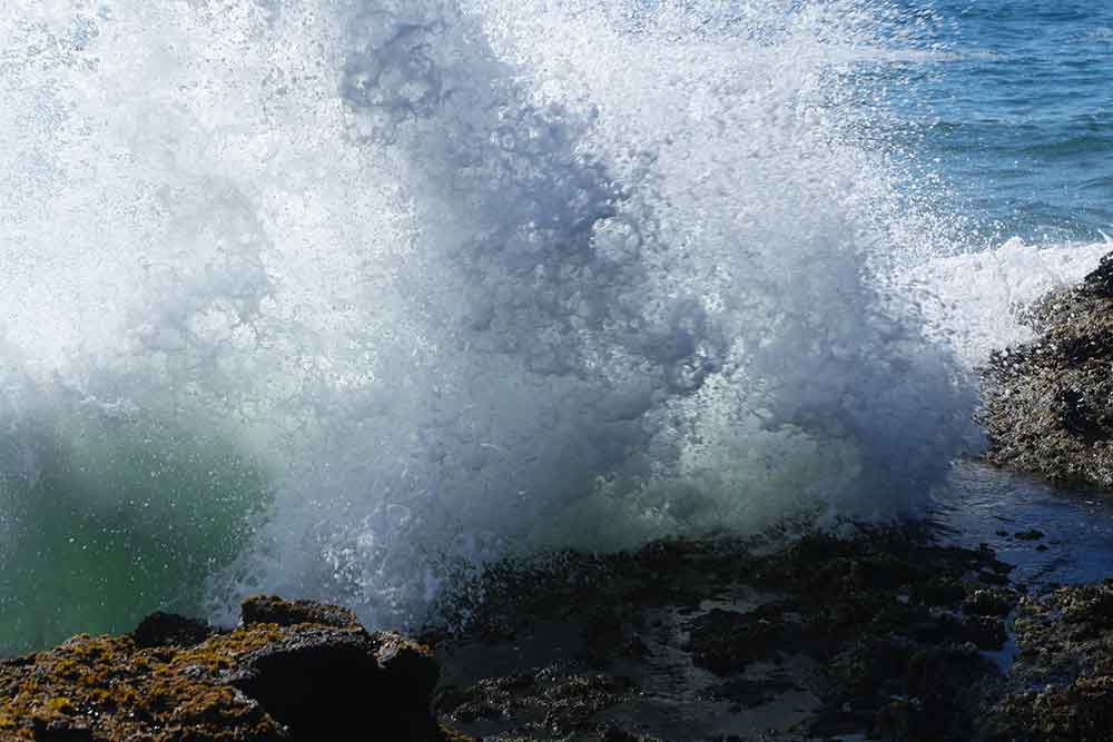 Photo of an Ocean Wave on Rocks
